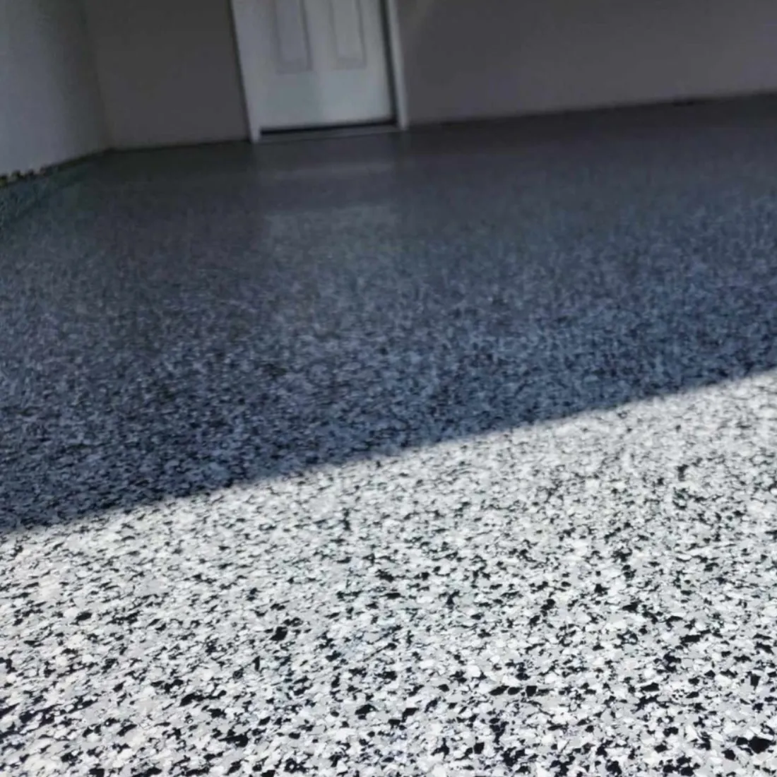 Black and white flake epoxy floor detail installed near the Lake of the Ozarks