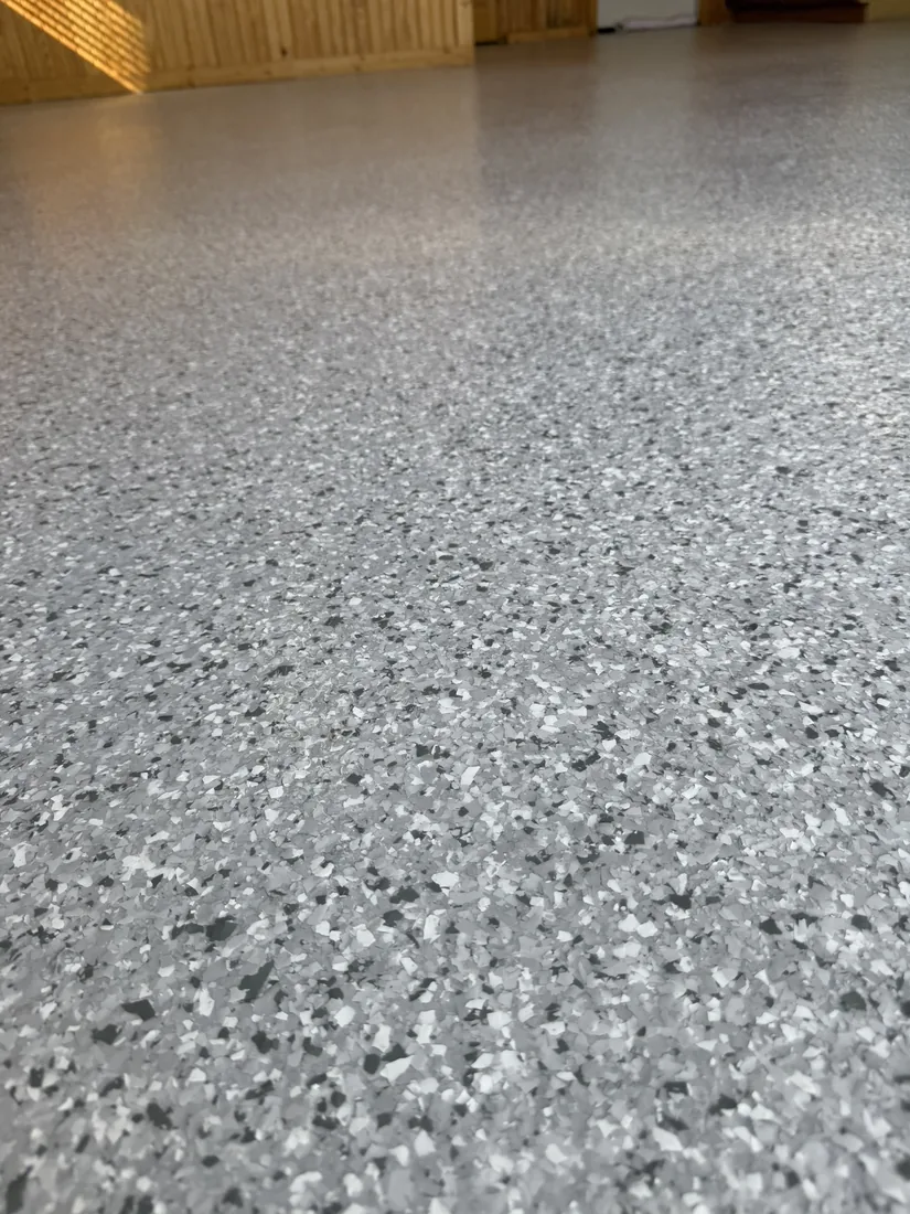 Closeup of gray white and black flake epoxy floor texture Belle Missouri