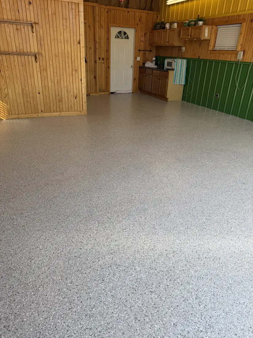 Finished gray white and black flake epoxy shop floor after coating Belle Missouri