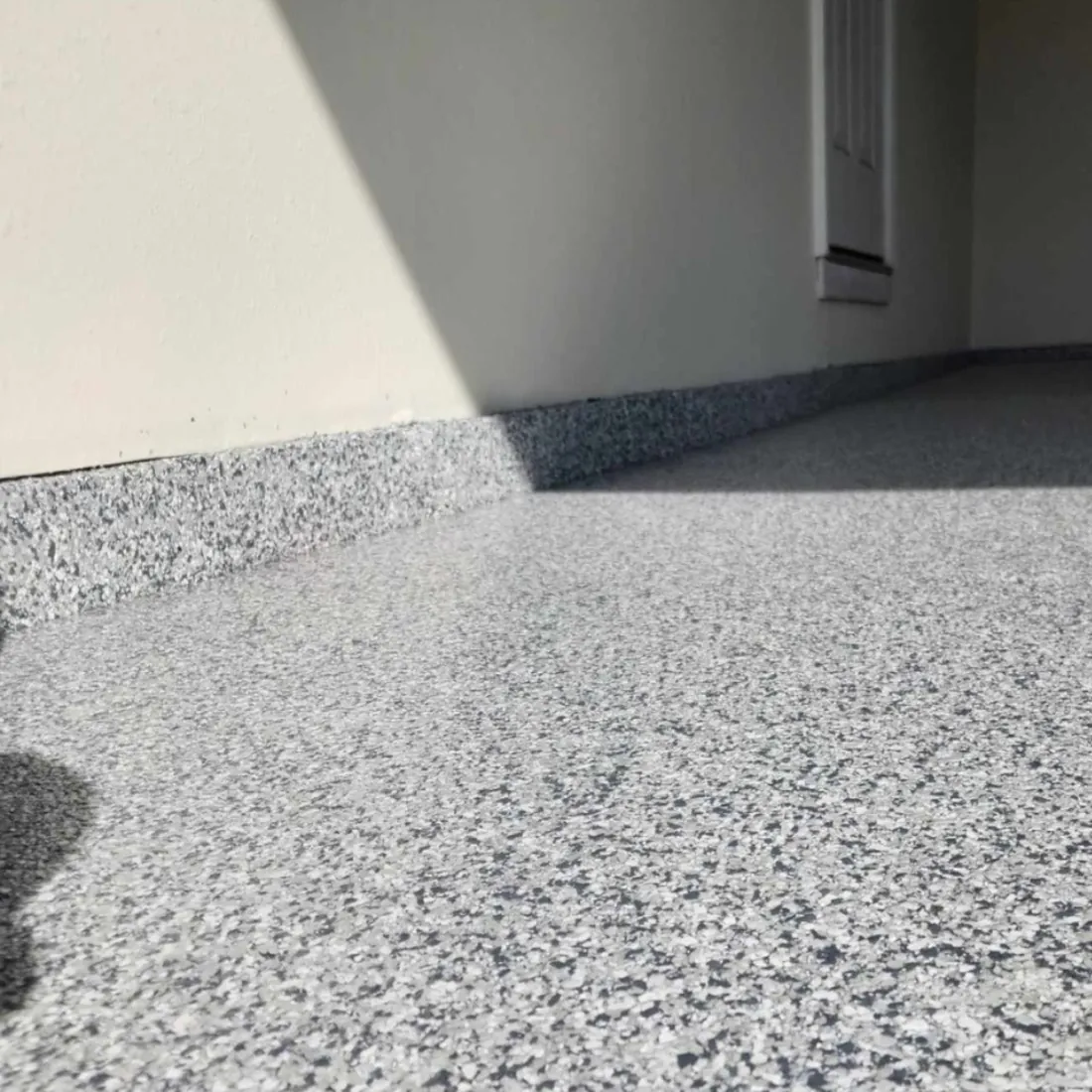 Cove base transition detail on an epoxy floor in a rural Mid-Missouri shop