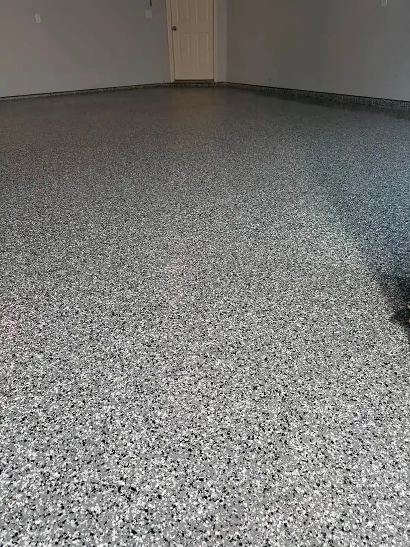 Wide angle finished gray flake epoxy garage floor Holts Summit Missouri