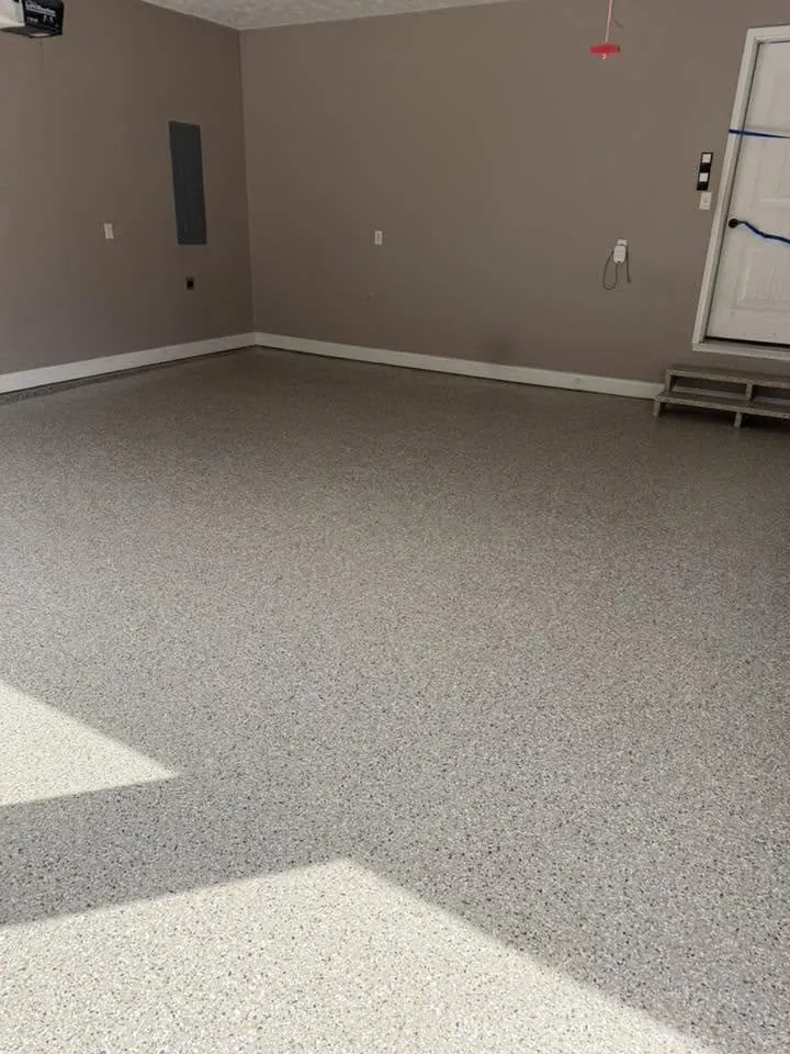 Finished tan gray black flake epoxy garage floor after coating Wardsville Missouri