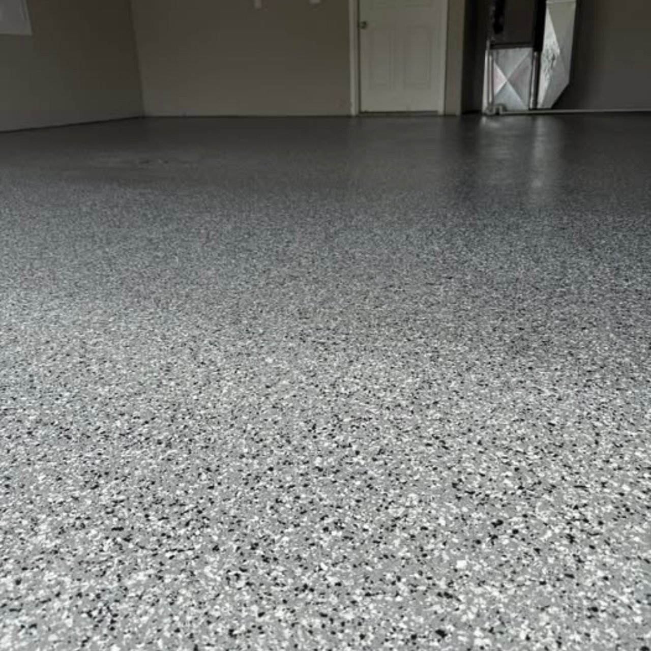 Black and white large flake epoxy garage floor Jefferson City