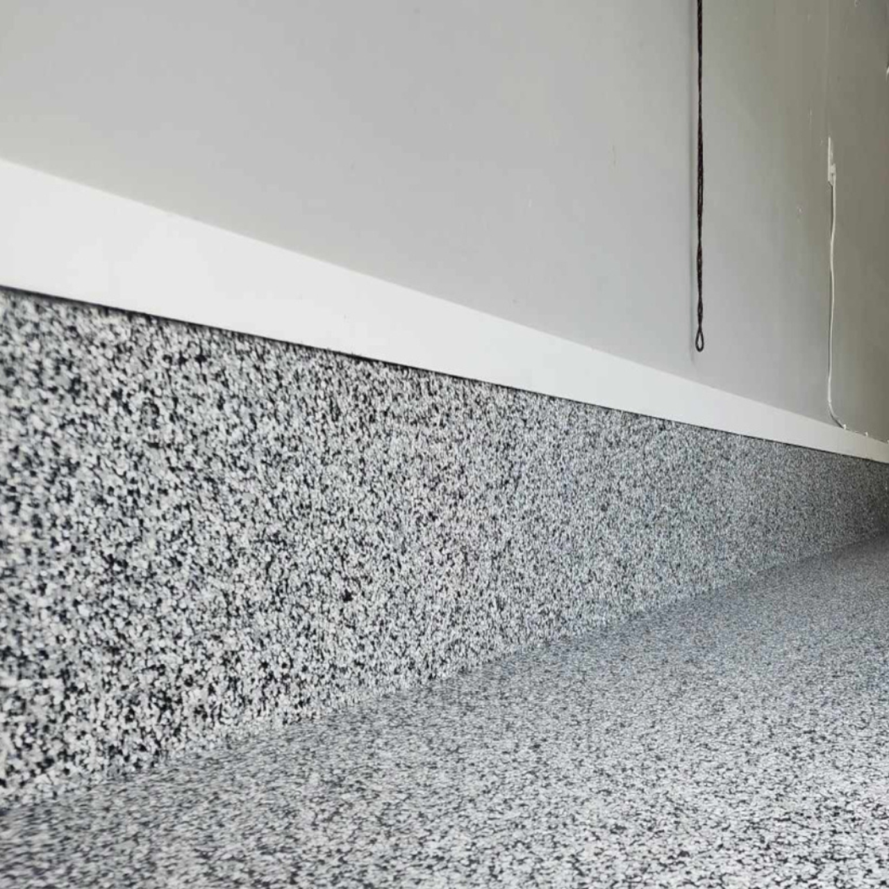 Cove base detail on a flake epoxy shop floor for durability