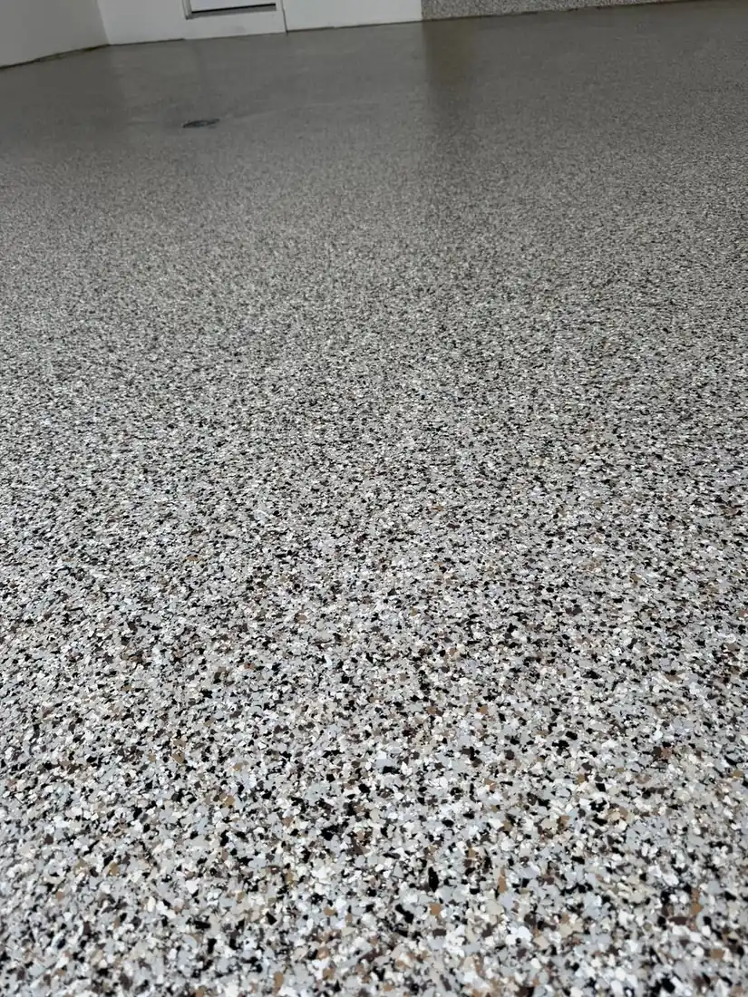 Closeup of tan brown gray flake epoxy floor texture Jefferson City Missouri