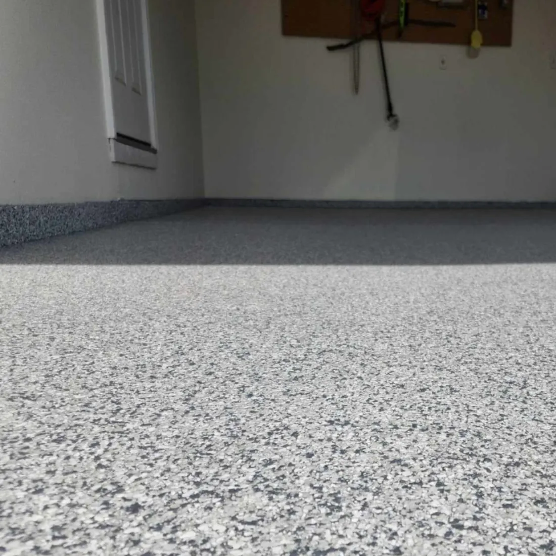 Closeup of light gray flake epoxy garage floor finish in Mid-Missouri