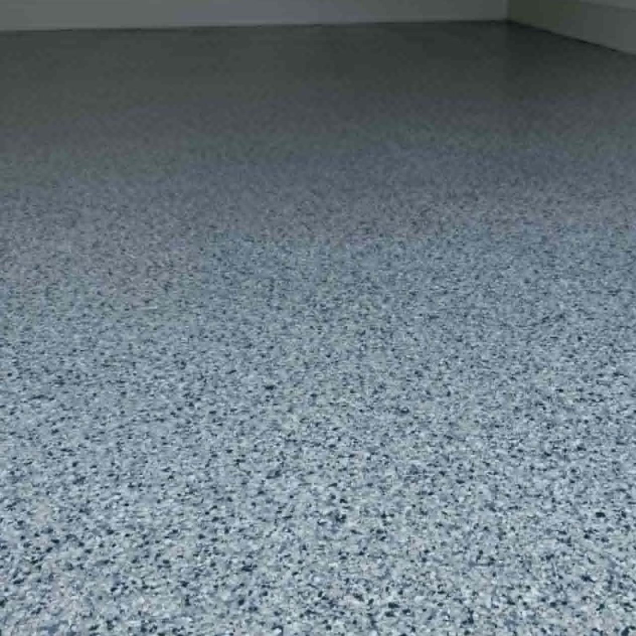 Light gray flake epoxy floor large open garage Missouri