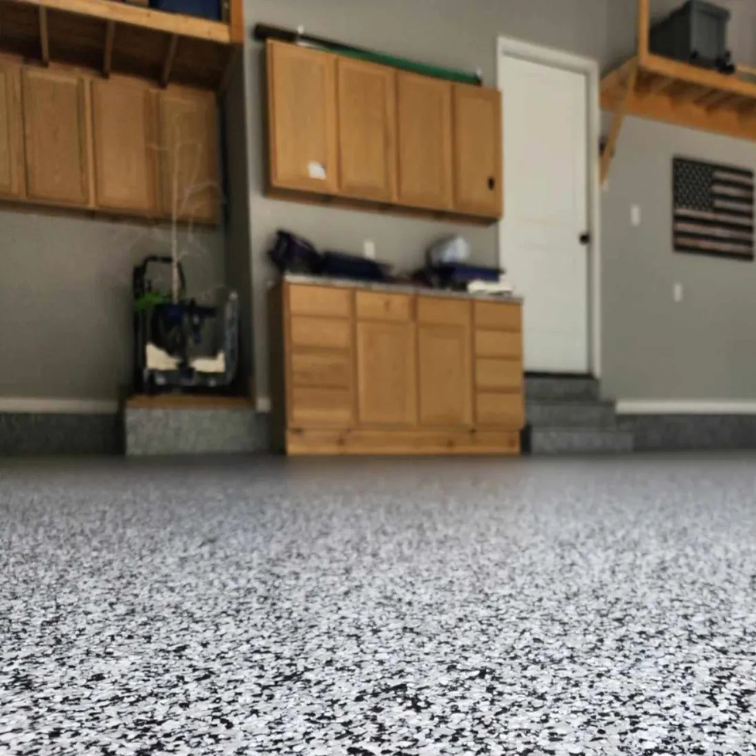 Garage workshop with cabinets black white flake epoxy floor