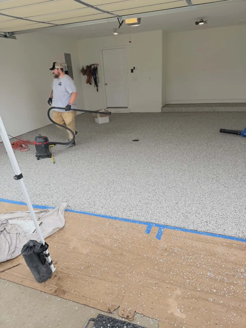 Show Me Epoxy crew vacuuming finished garage floor Jefferson City Missouri