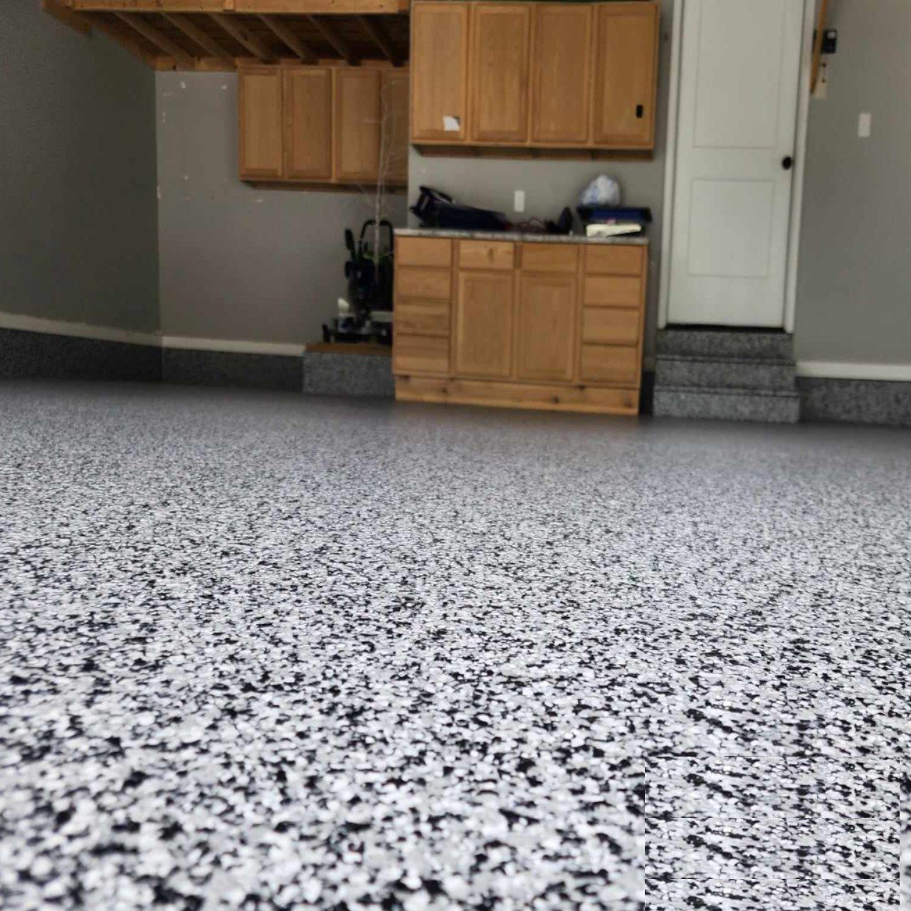 Finished epoxy garage floor with vehicles parked showing daily durability Jefferson City Missouri