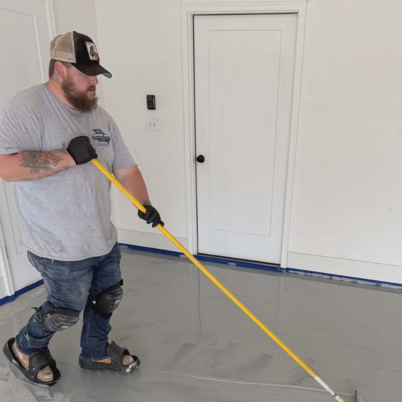 Show Me Epoxy installer applying base coat garage floor Jefferson City Missouri