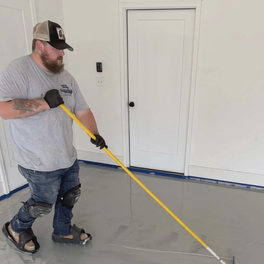 Show Me Epoxy installer applying base coat garage floor Jefferson City Missouri