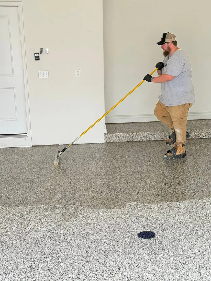 Show Me Epoxy installer applying polyaspartic topcoat garage floor Jefferson City Missouri