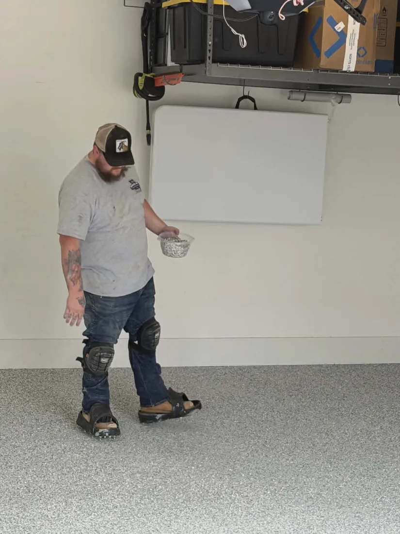 Show Me Epoxy installer collecting hardware after finishing a garage floor