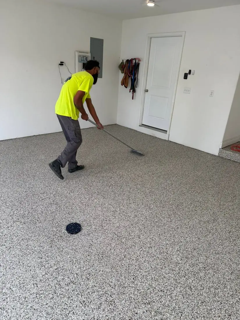 Show Me Epoxy installer finishing flake floor with squeegee Jefferson City Missouri