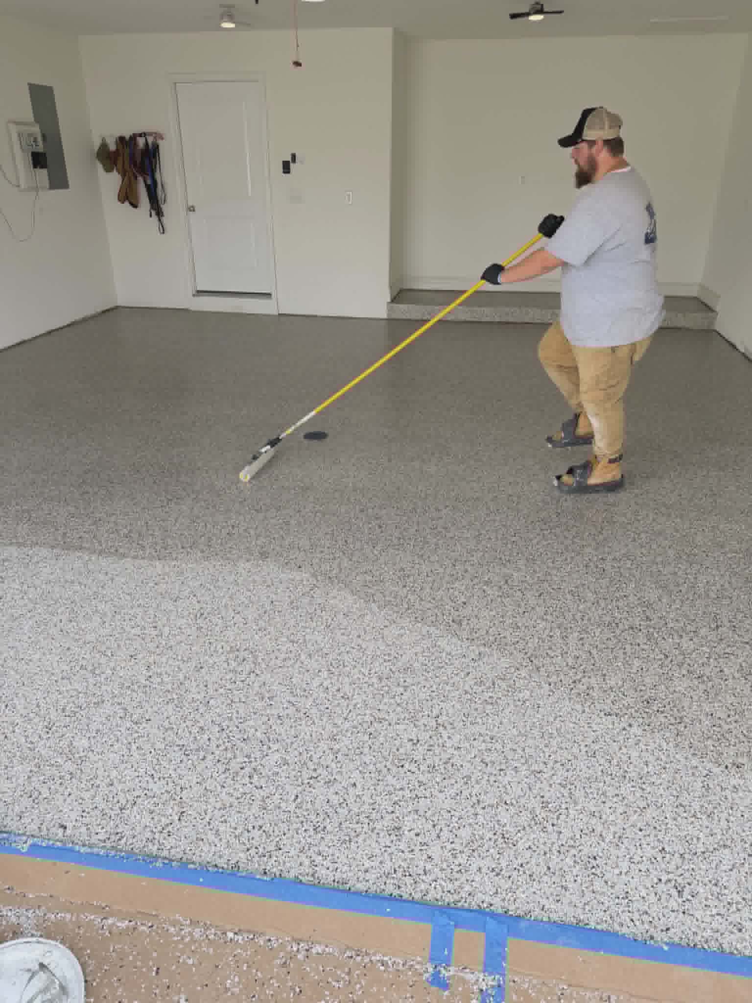 Show Me Epoxy installer finishing topcoat on garage floor Jefferson City Missouri