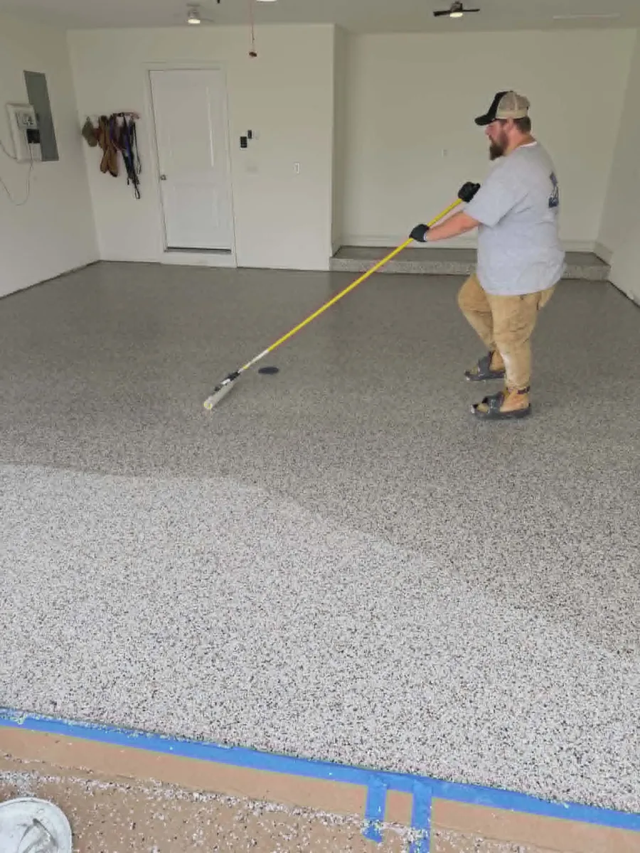 Show Me Epoxy installer finishing topcoat on garage floor Jefferson City Missouri