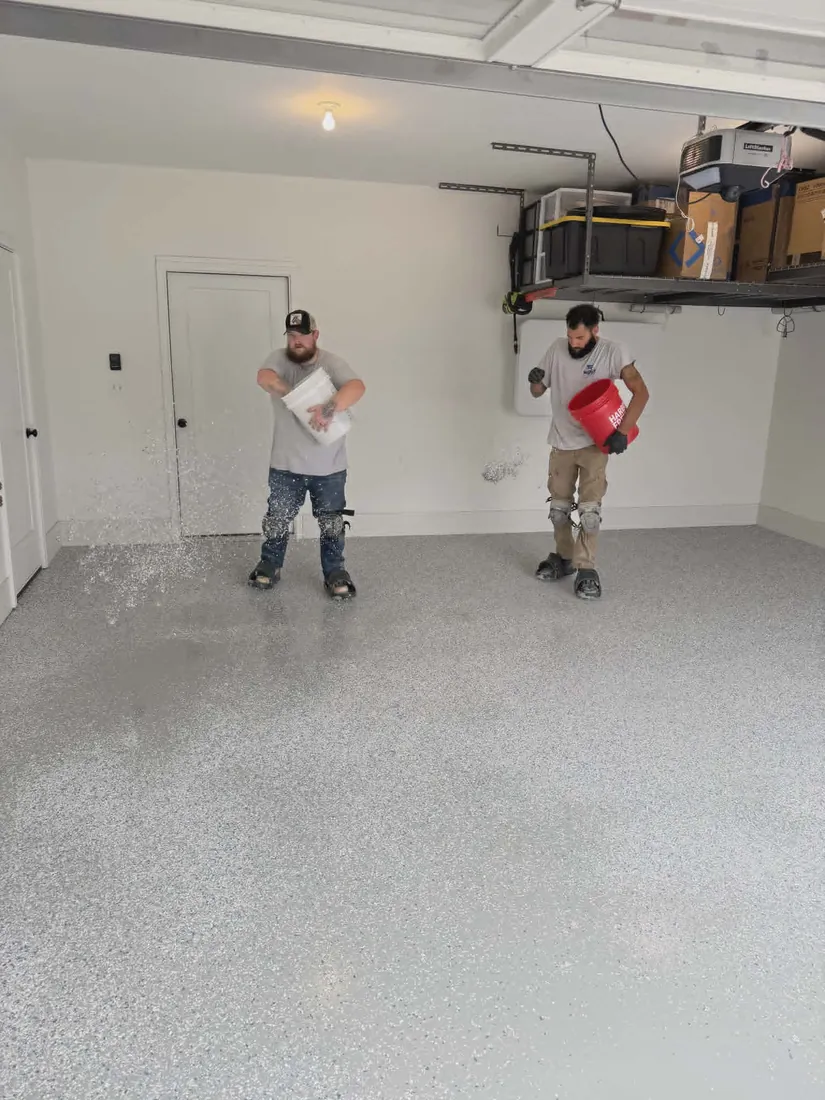 Two-man Show Me Epoxy crew broadcasting flake on garage floor Missouri